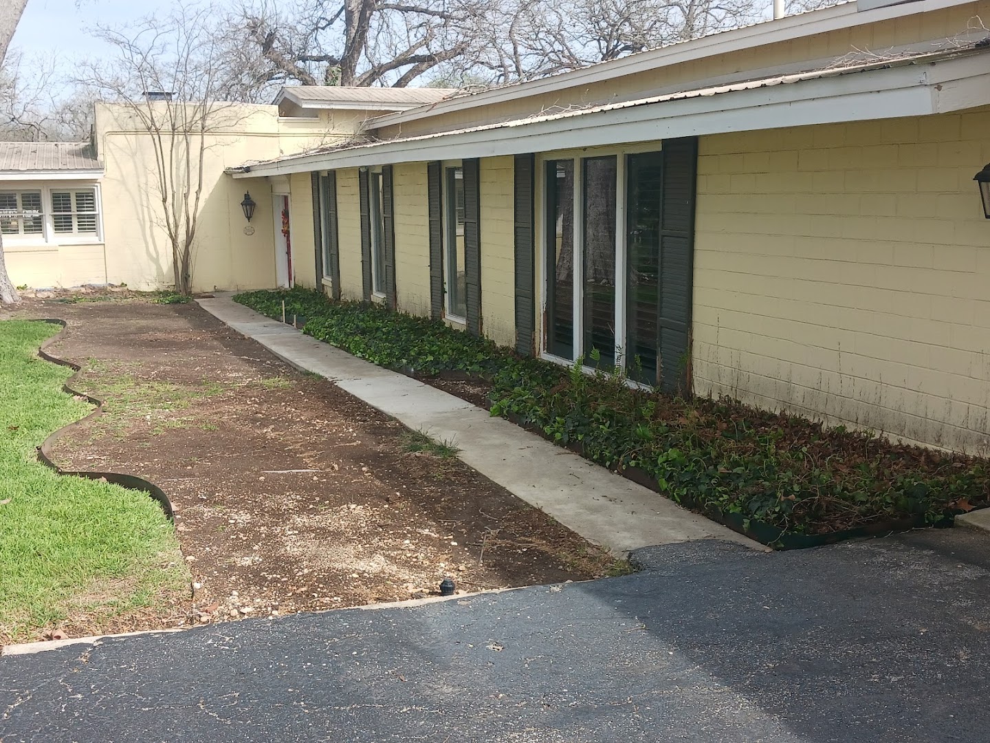 Concrete walkway running along a home, hill country TX