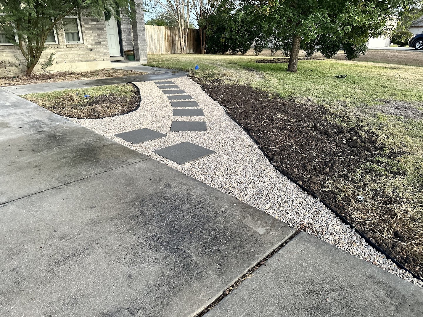 Flagstone walkway across a landscaped yard, hill country TX