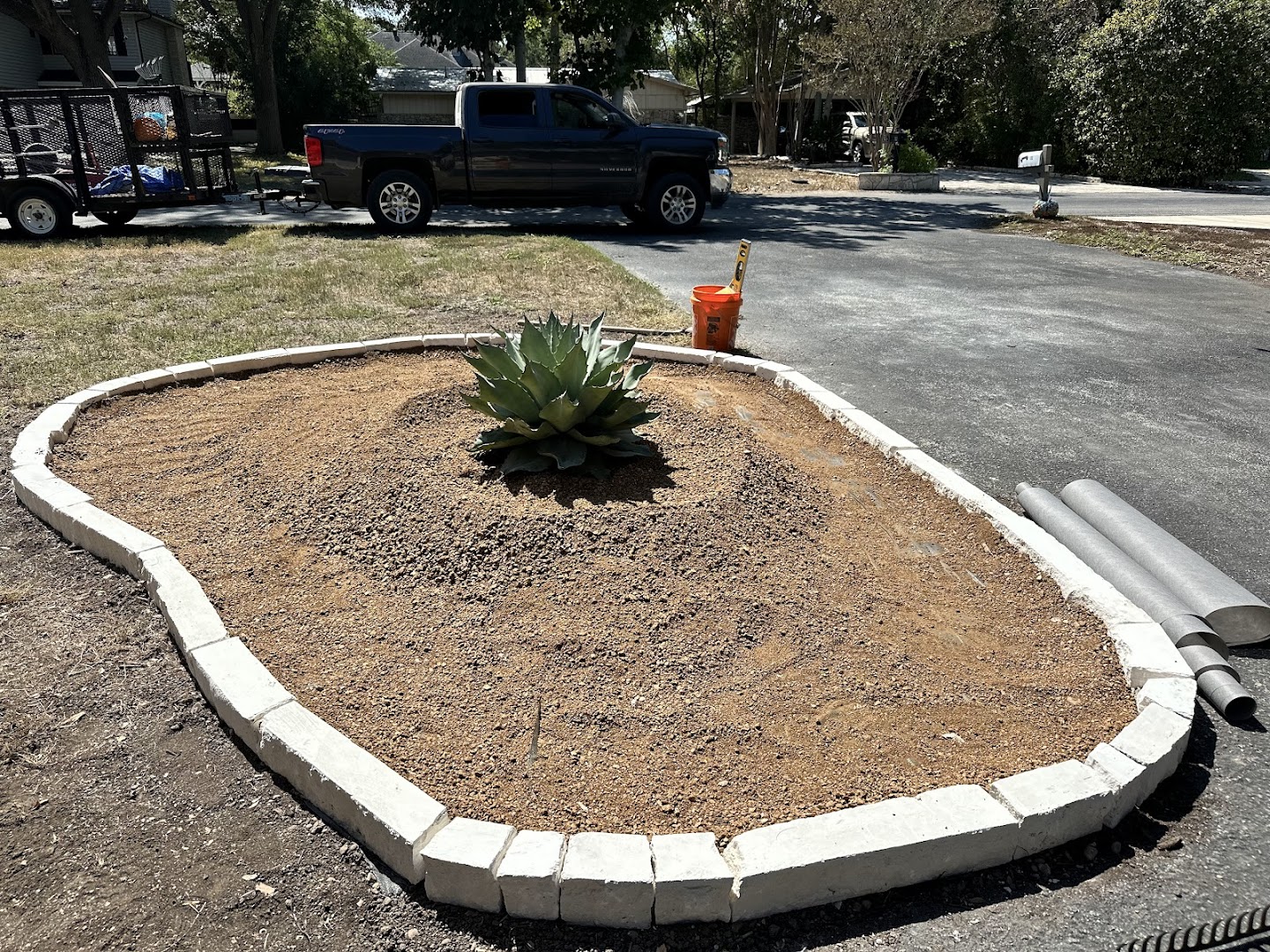 Landscape bed with concrete border and plantings, Seguin TX