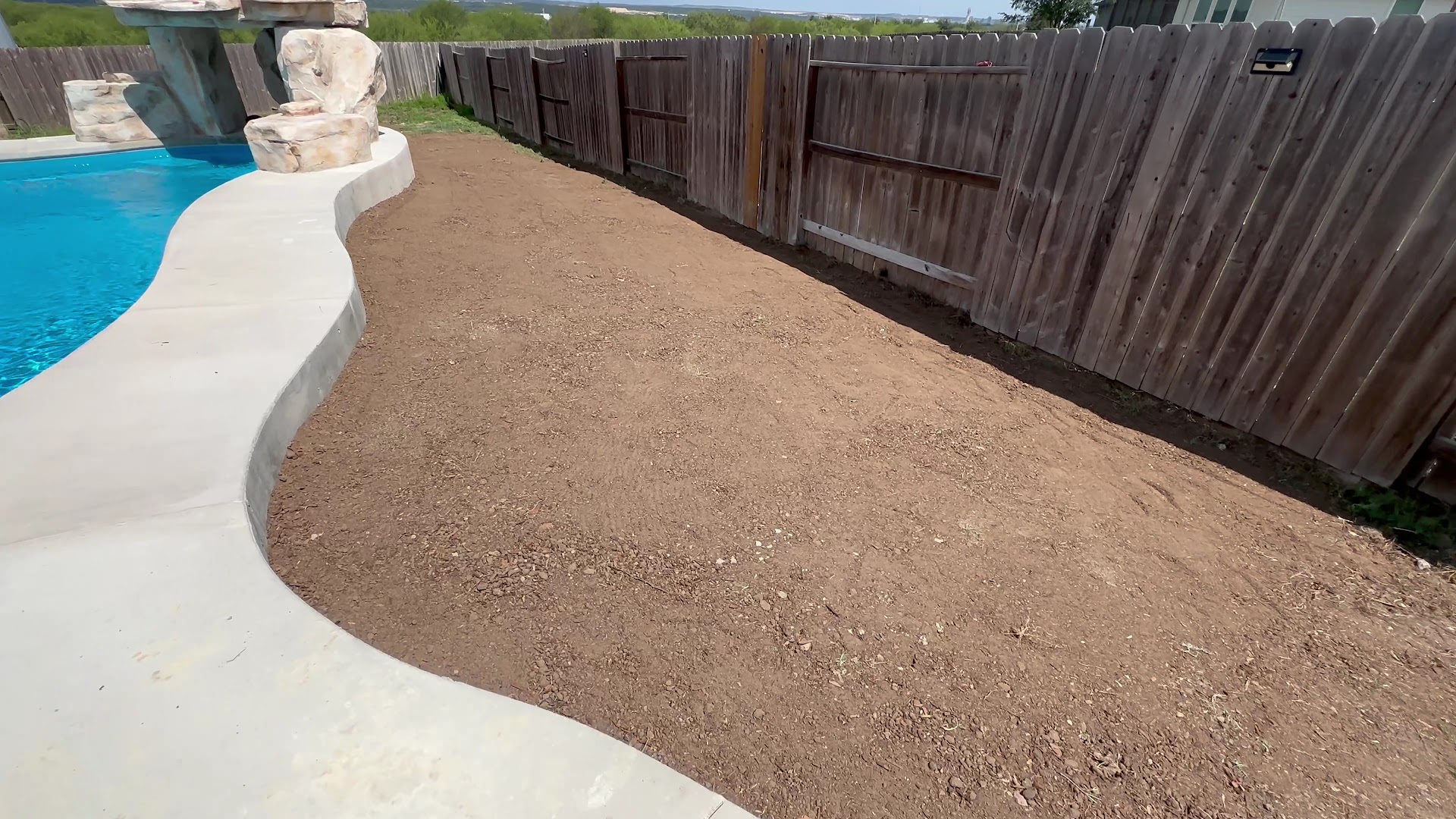 Curved concrete pool deck, Texas hill country