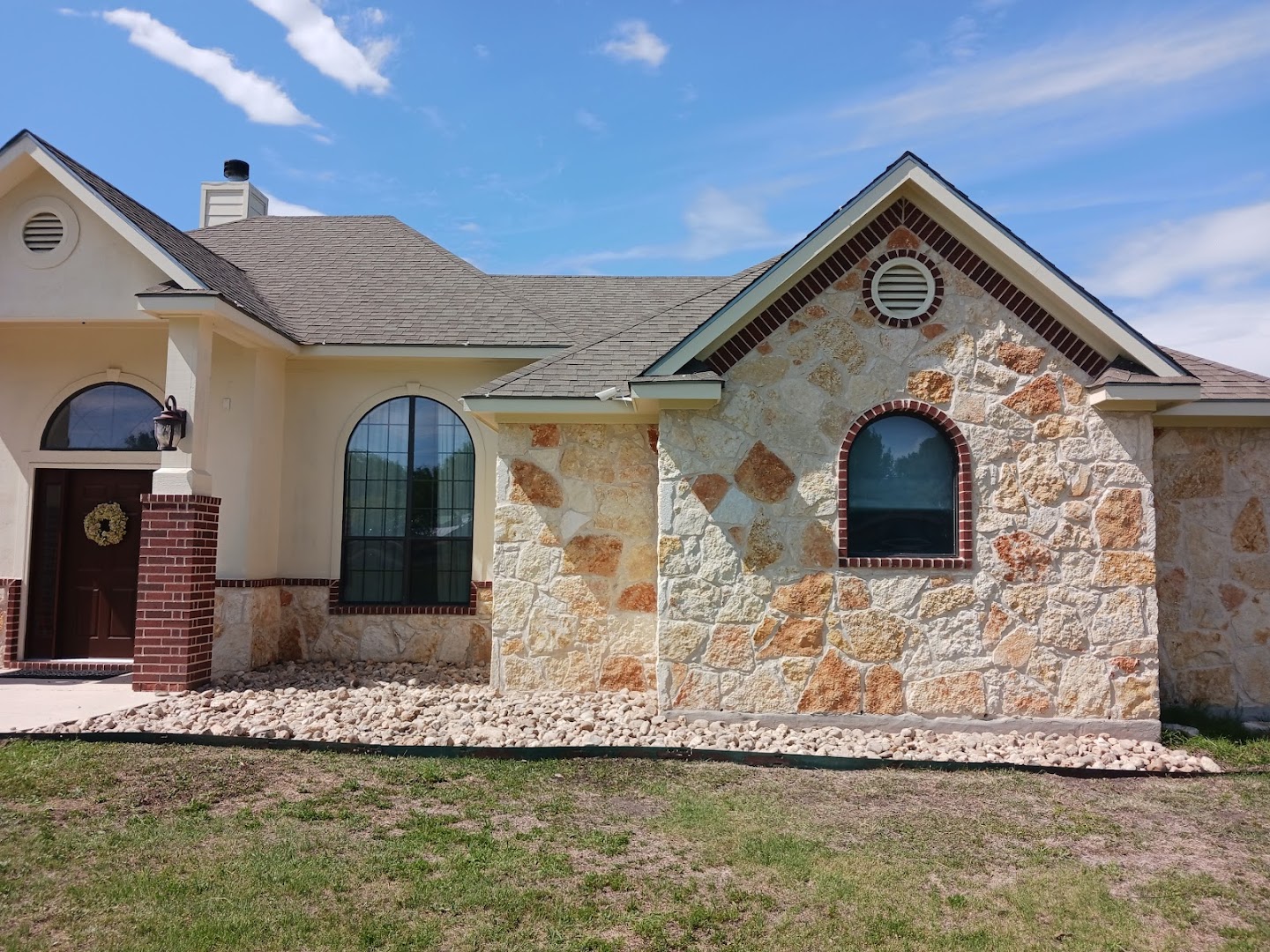Stone home with fresh landscaping, Texas hill country